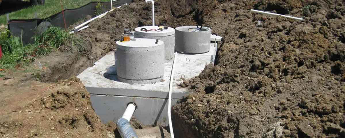 Septic system repair and installation site with tank access ports in Des Moines, IA